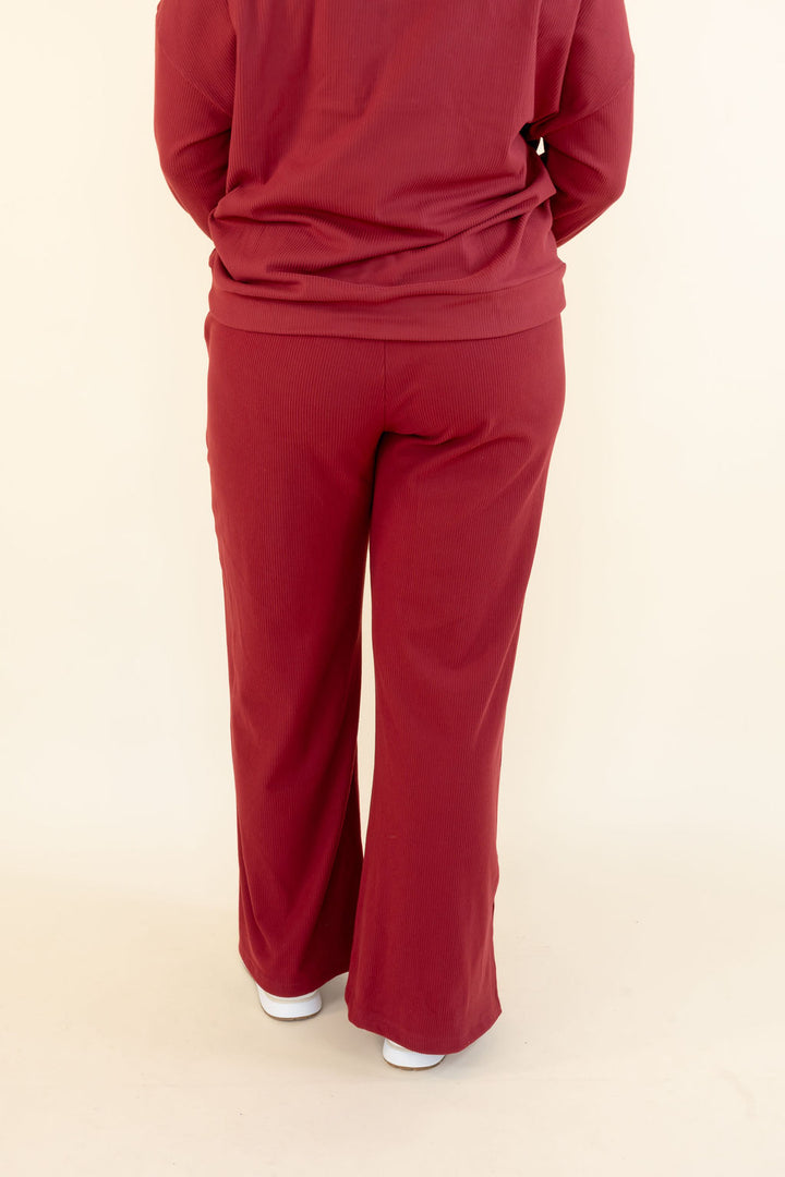 Back view of deep red wide leg pants showing relaxed fit and full-length wide leg silhouette