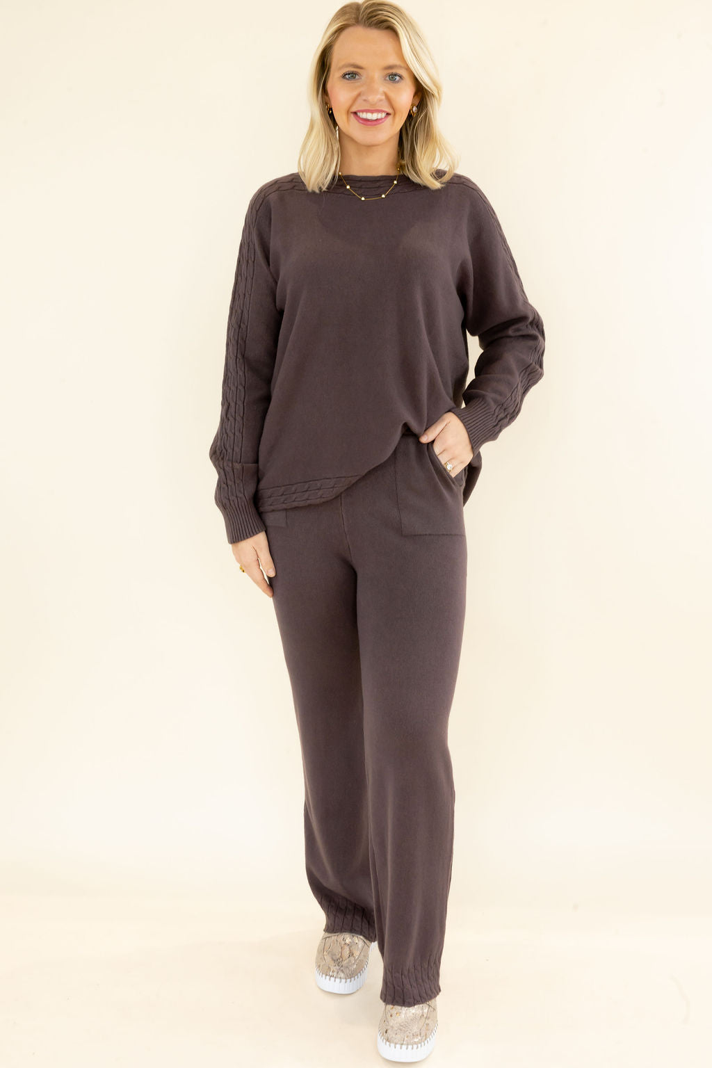 Woman modeling chocolate brown matching knit set with long sleeve pullover and wide leg pants featuring convenient side pockets