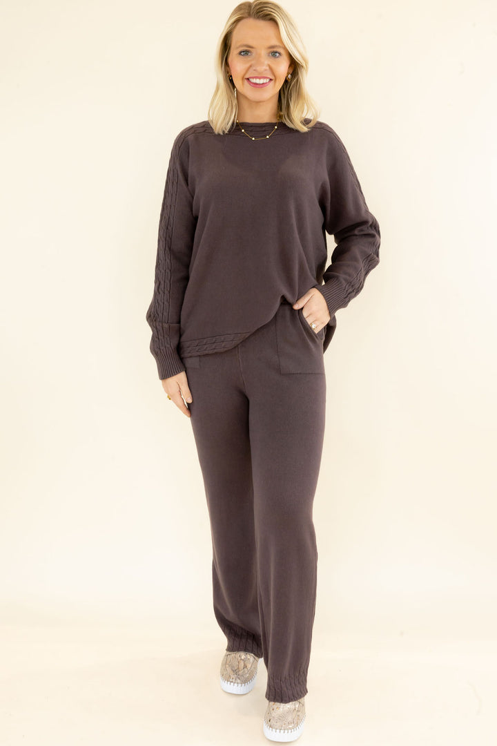 Woman modeling chocolate brown matching knit set with long sleeve pullover and wide leg pants featuring convenient side pockets