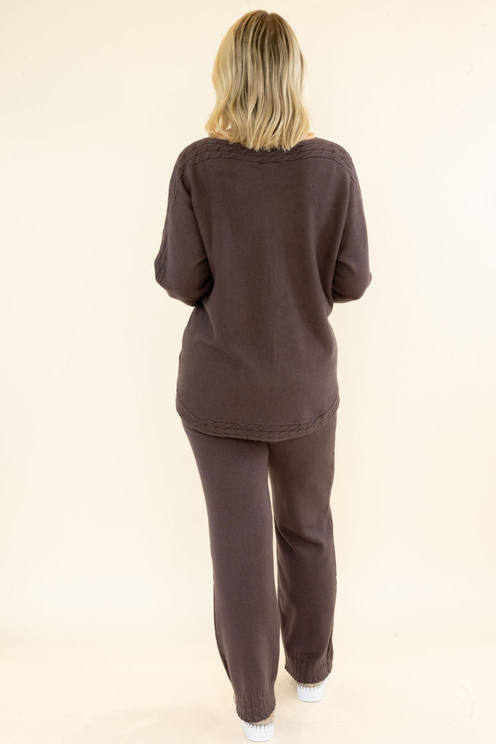Back view of woman wearing chocolate brown matching knit set with relaxed long sleeve pullover and coordinating wide leg pants