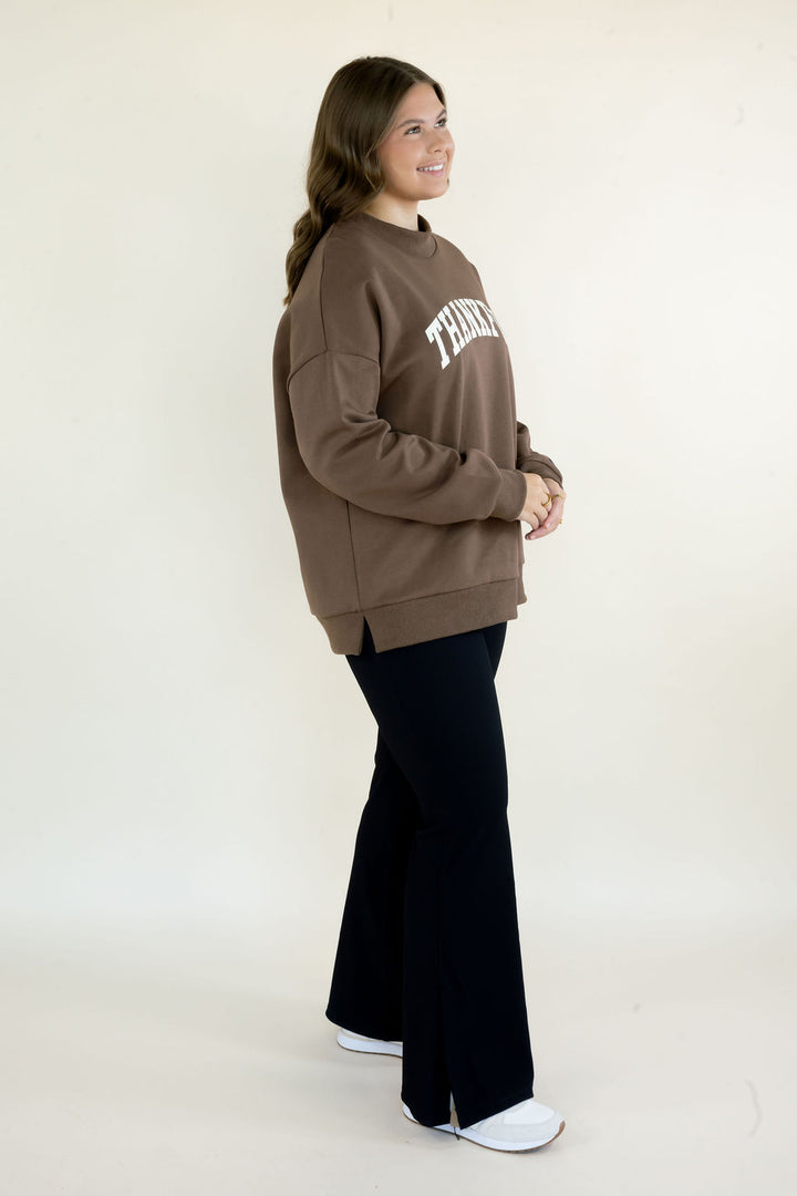 Side view of brown Thankful reversible mockneck sweatshirt showing relaxed fit, long sleeves, and longer hemline