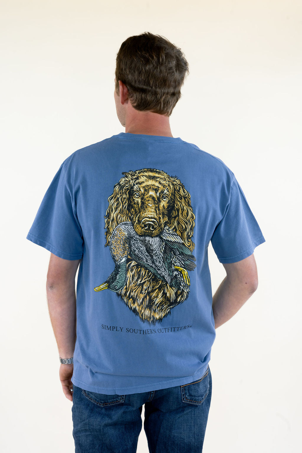 Man modeling blue Simply Southern men’s graphic T-shirt featuring a large hunting dog with bird back graphic, short sleeves, and relaxed fit