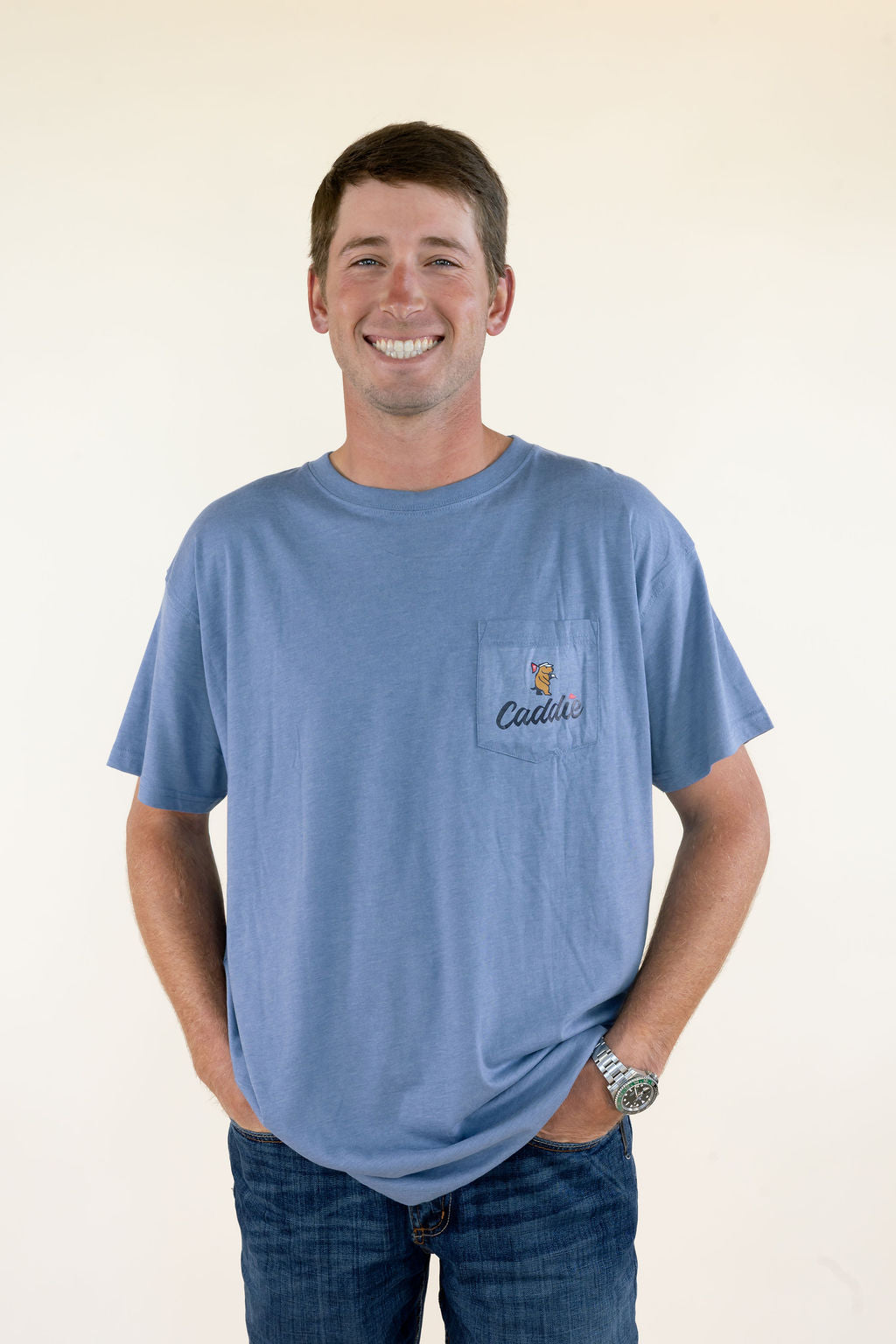 Front view of blue Caddie men’s graphic T-shirt featuring crew neckline, relaxed fit, short sleeves, and small chest graphic