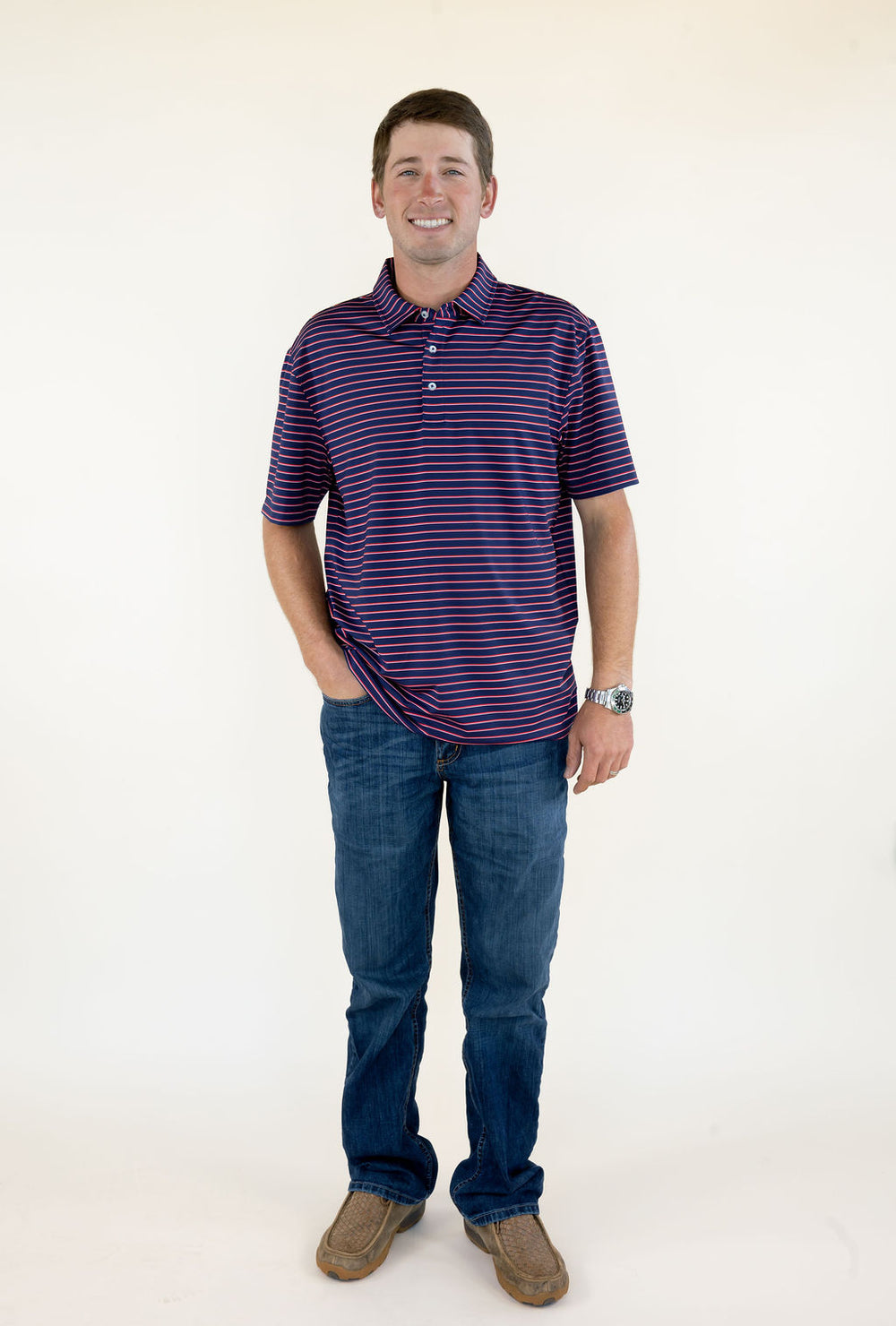 Front view of blue and red striped men’s performance polo featuring short sleeves, button placket, classic collar, and relaxed fit