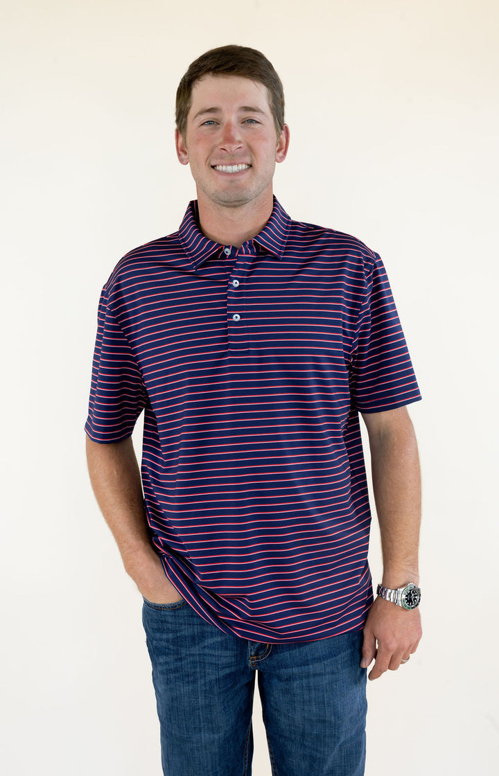 man wearing blue and red striped short sleeve performance polo with blue jeans