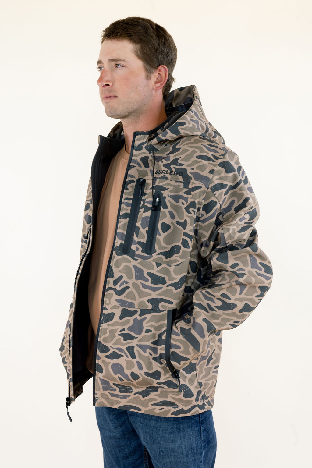Side view of male model wearing the Burlebo Challenger Gauge Camo jacket showing the relaxed fit and outdoor design.