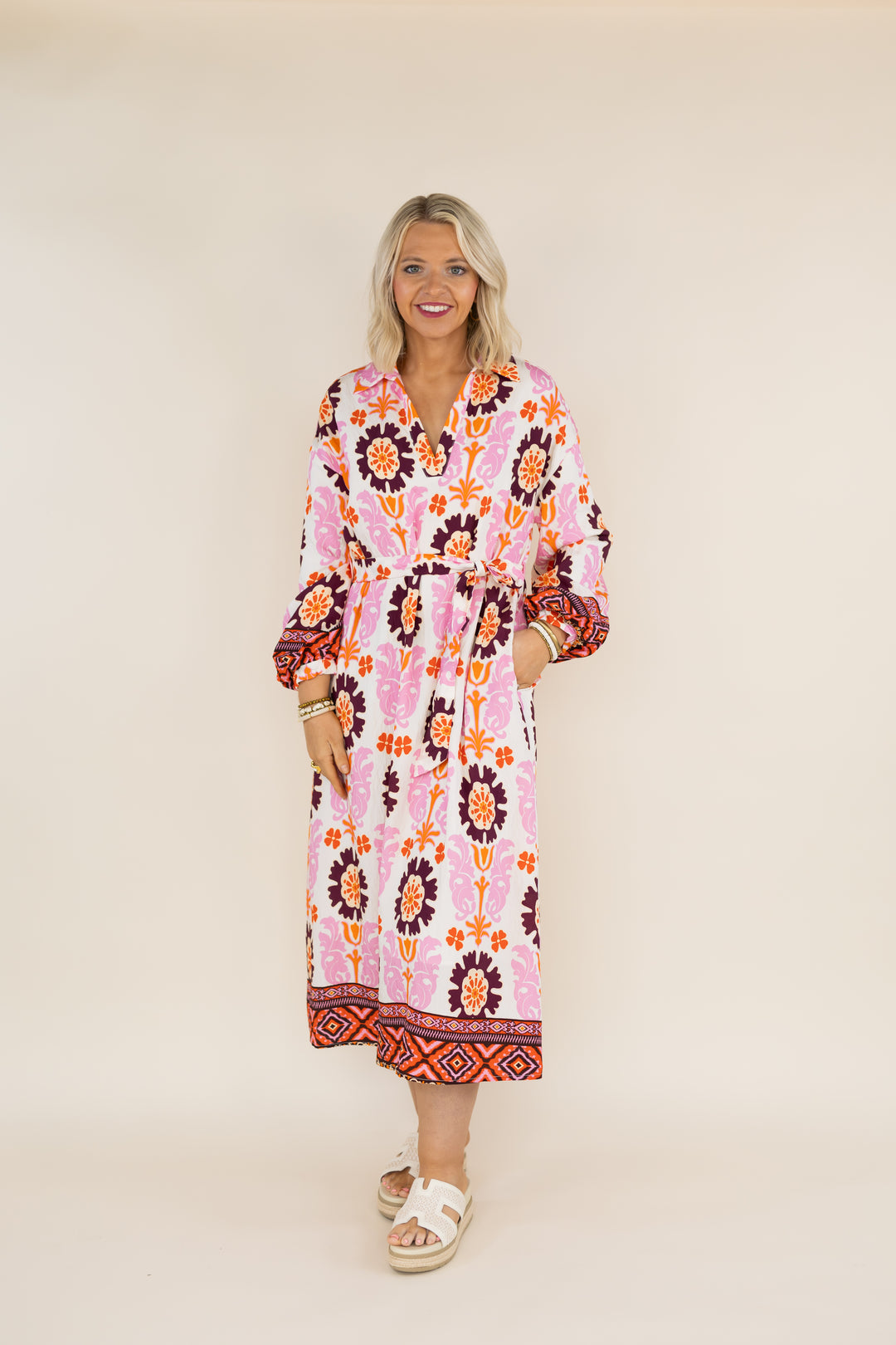 Woman wearing THML Marigold Bloom floral tie waist midi dress, full front view