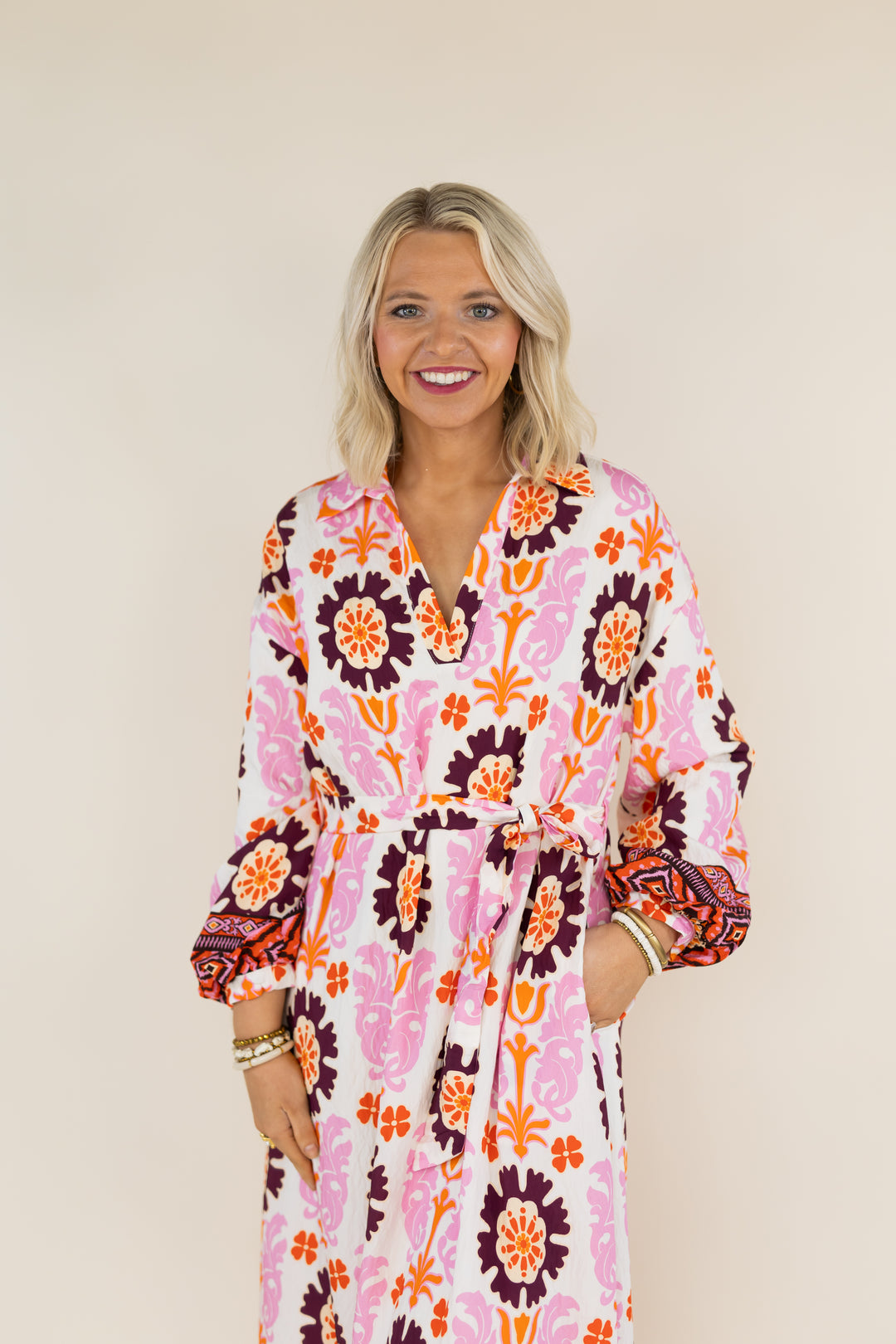 Woman modeling THML Marigold Bloom pink multi floral tie waist midi dress