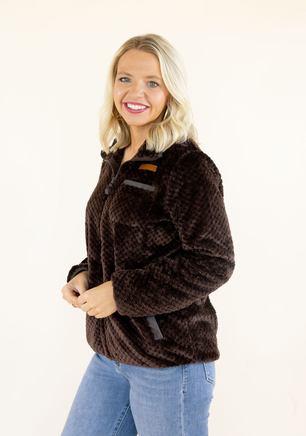 Women's chocolate brown plush fleece jacket featuring a full zip-front closure, cozy textured fabric, and relaxed silhouette for casual fall and winter outfits.
