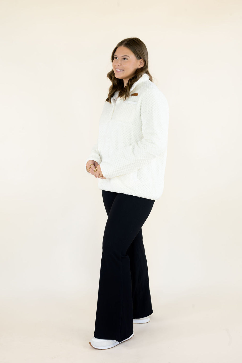 Simply Southern Simply Soft Pullover in ivory featuring plush textured fabric, snap-button collar, and front pockets, styled with black flare pants.