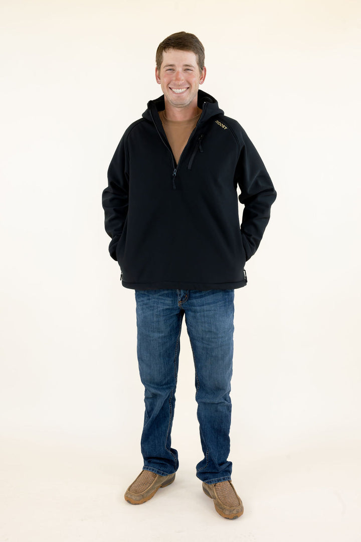 Male model wearing the black Roost Defender soft shell quarter zip pullover with blue jeans, full-body front view.
