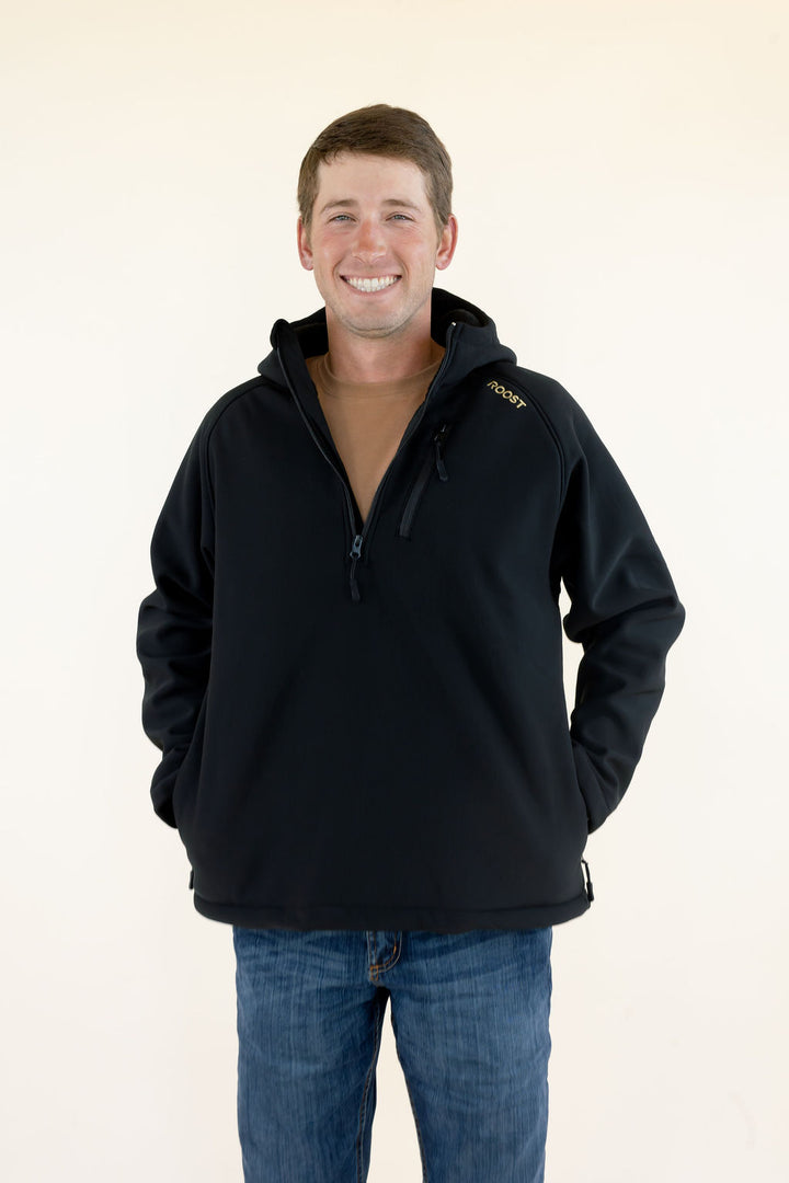 Front view of male model wearing the black Roost Defender hooded quarter zip pullover with zippered pockets.