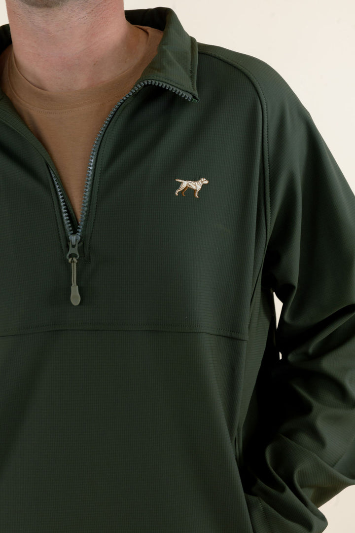 Close-up of the green Dogwood Pullover showing the deep quarter-zip neckline, chest logo and soft shell fabric.