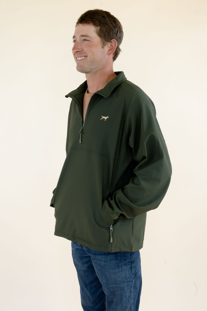 Side view of male model wearing the green Dogwood soft shell quarter zip pullover showing the fit and silhouette.