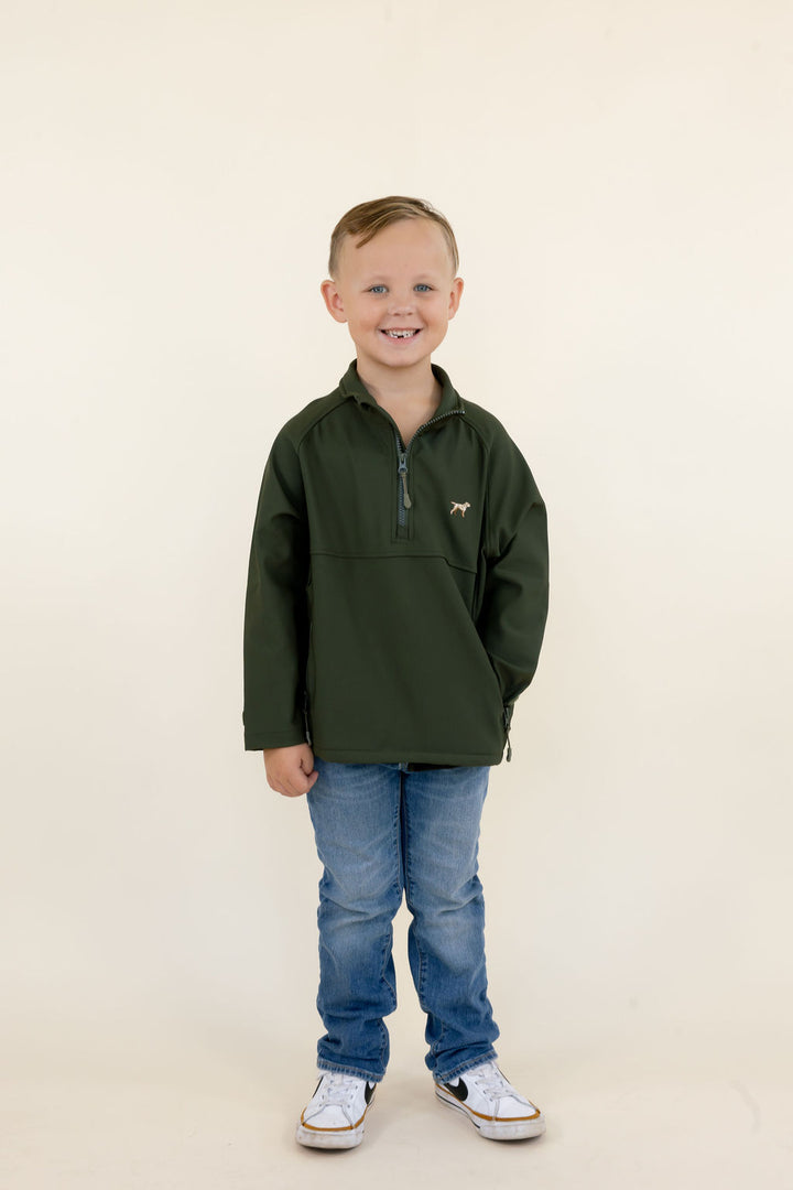 Youth model wearing the green Dogwood soft shell quarter zip pullover with blue jeans and sneakers, full-body front view.