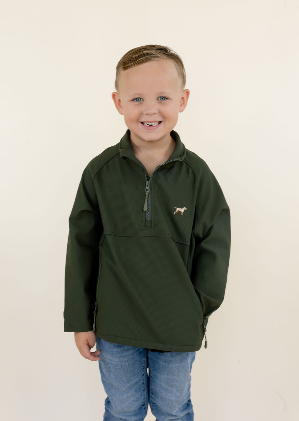 Front view of youth model wearing the green Dogwood quarter zip pullover with chest logo and lower zippered pockets.