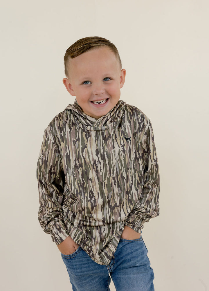 Close-up front view of boys youth performance hoodie in brown, green, tan, and cream camouflage with a relaxed hooded neckline and small chest logo.