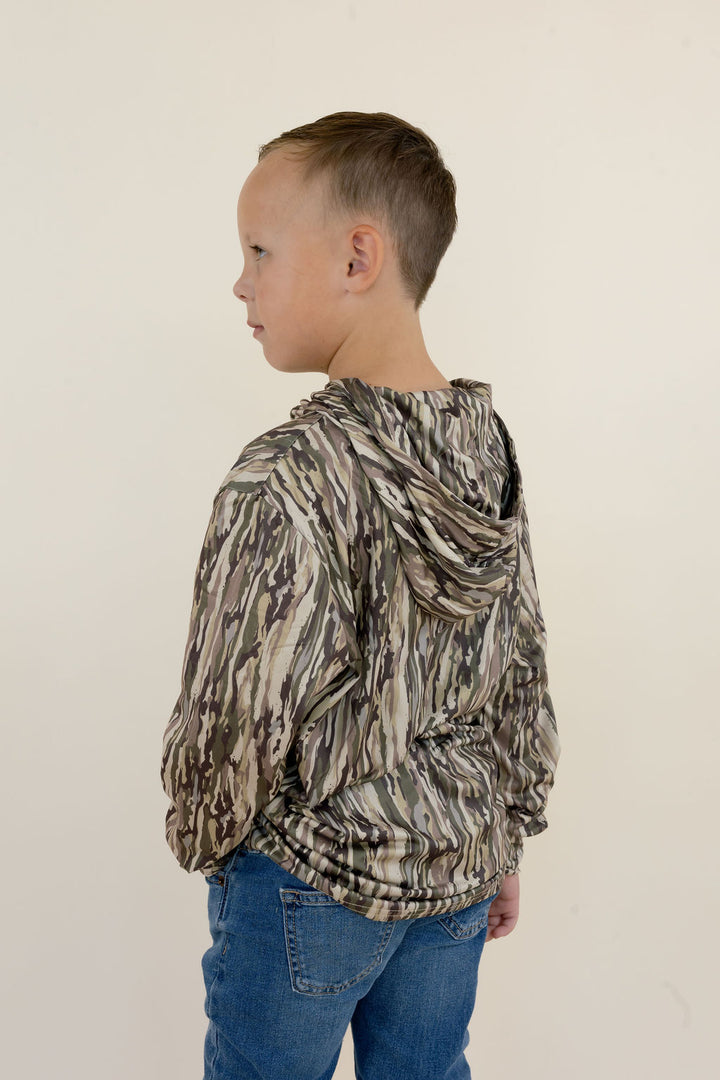 Back and side view of youth camo performance hoodie showing the attached hood, all-over camouflage pattern, long sleeves, and relaxed fit.