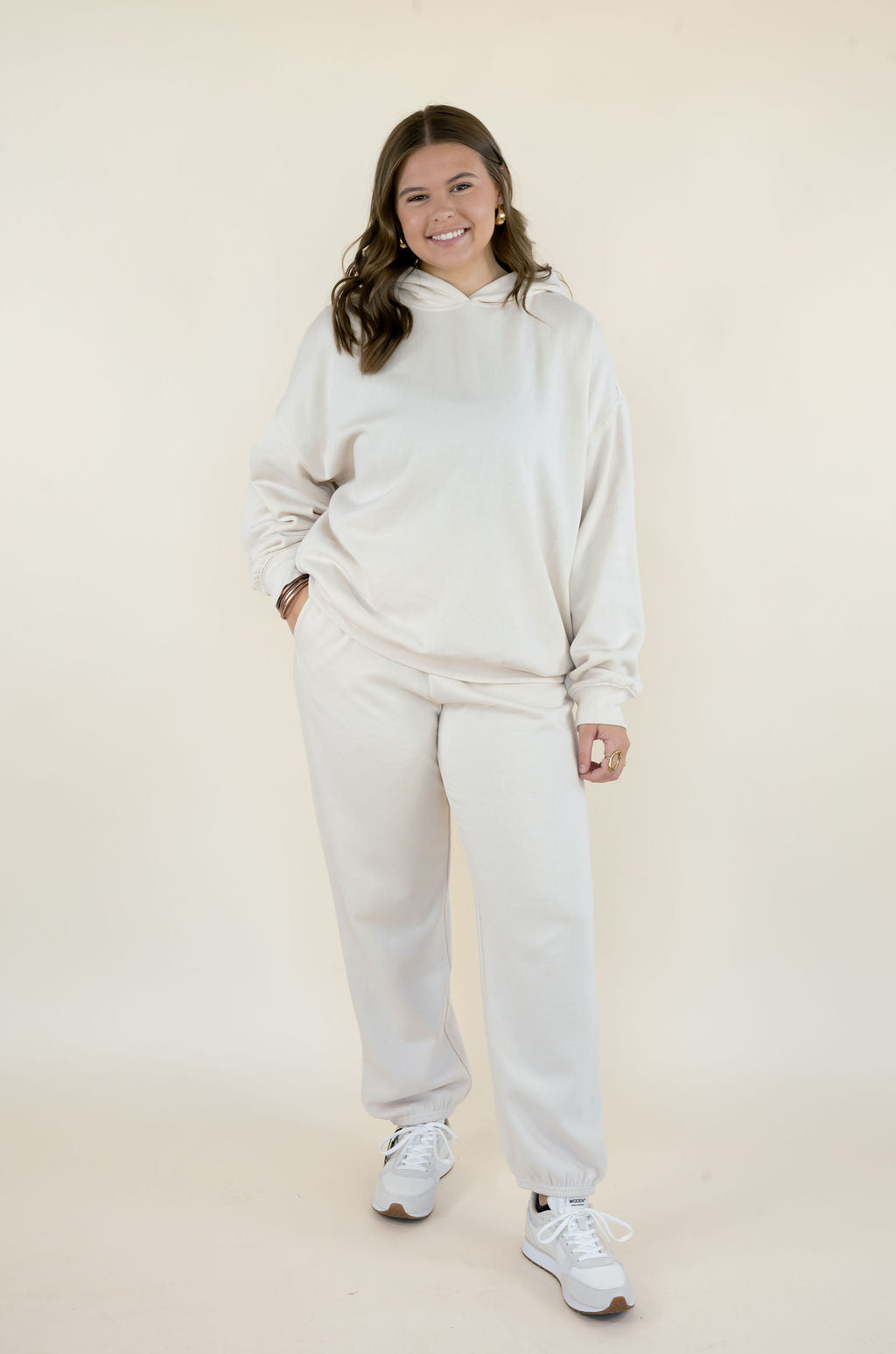 Full-length front view of Uptown Classic Fleece Joggers in Frosted Pearl styled with matching First Quarter Hoodie and white sneakers.