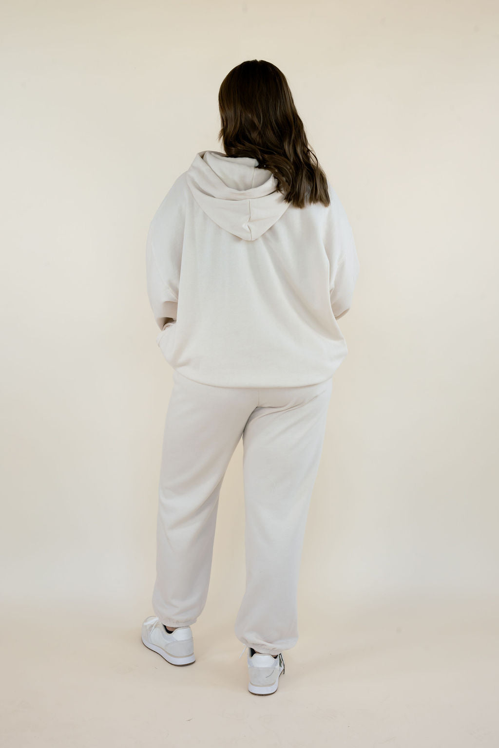 Full back view of First Quarter Hoodie in Frosted Pearl showing the oversized fit, attached hood, ribbed hem, and matching cream fleece joggers.