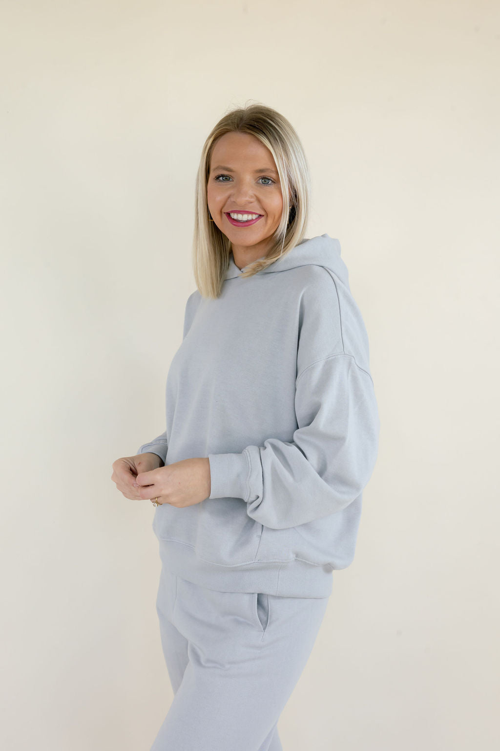Close-up side view of Silverlake First Quarter Hoodie showing dropped shoulders, long sleeves, ribbed cuffs, and soft fleece fabric.