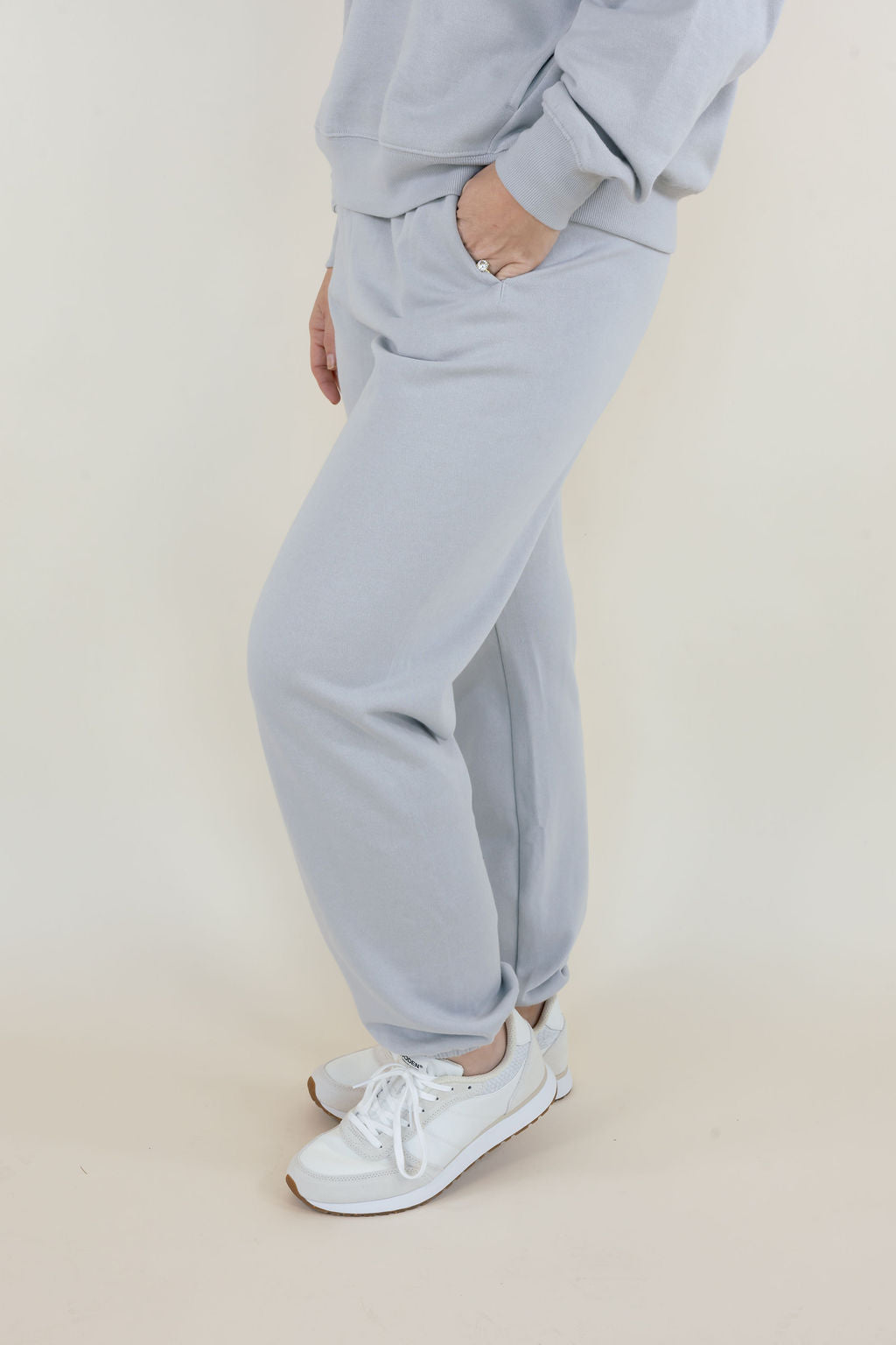 Side view of women's Silverlake Uptown Classic Fleece Joggers showing relaxed leg fit, elastic ankle cuffs, and white sneakers.