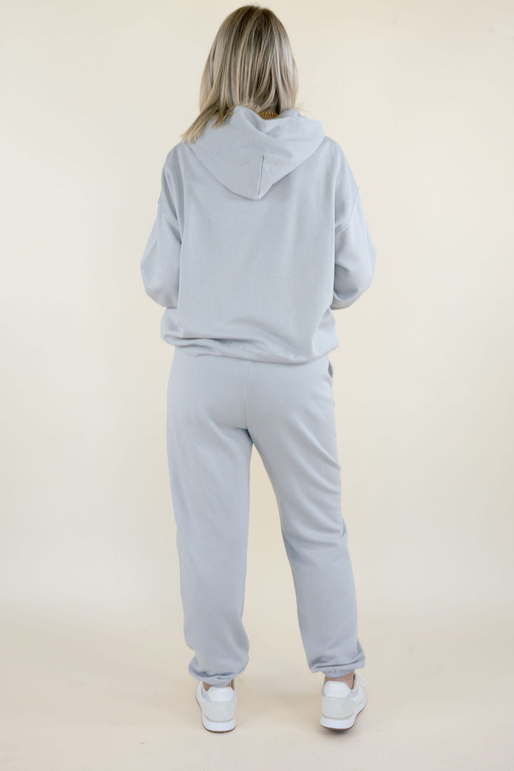 Back view of First Quarter Hoodie in Silverlake showing the relaxed silhouette, attached hood, and ribbed hem with matching jogger pants.