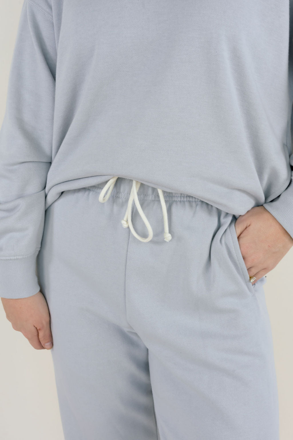 Close-up of Uptown Classic Fleece Jogger in Silverlake showing elastic drawstring waistband, soft cotton blend fleece, and side seam pocket.