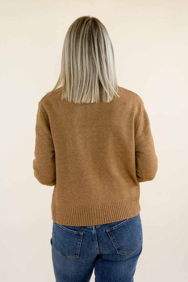 Close-up back view of camel brown sweater cardigan highlighting the soft knit texture, relaxed shoulder fit, long sleeves, and ribbed waistband