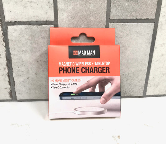 Packaging of a magnetic wireless tablet phone charger with 'Mad Man' branding on a tiled floor background.