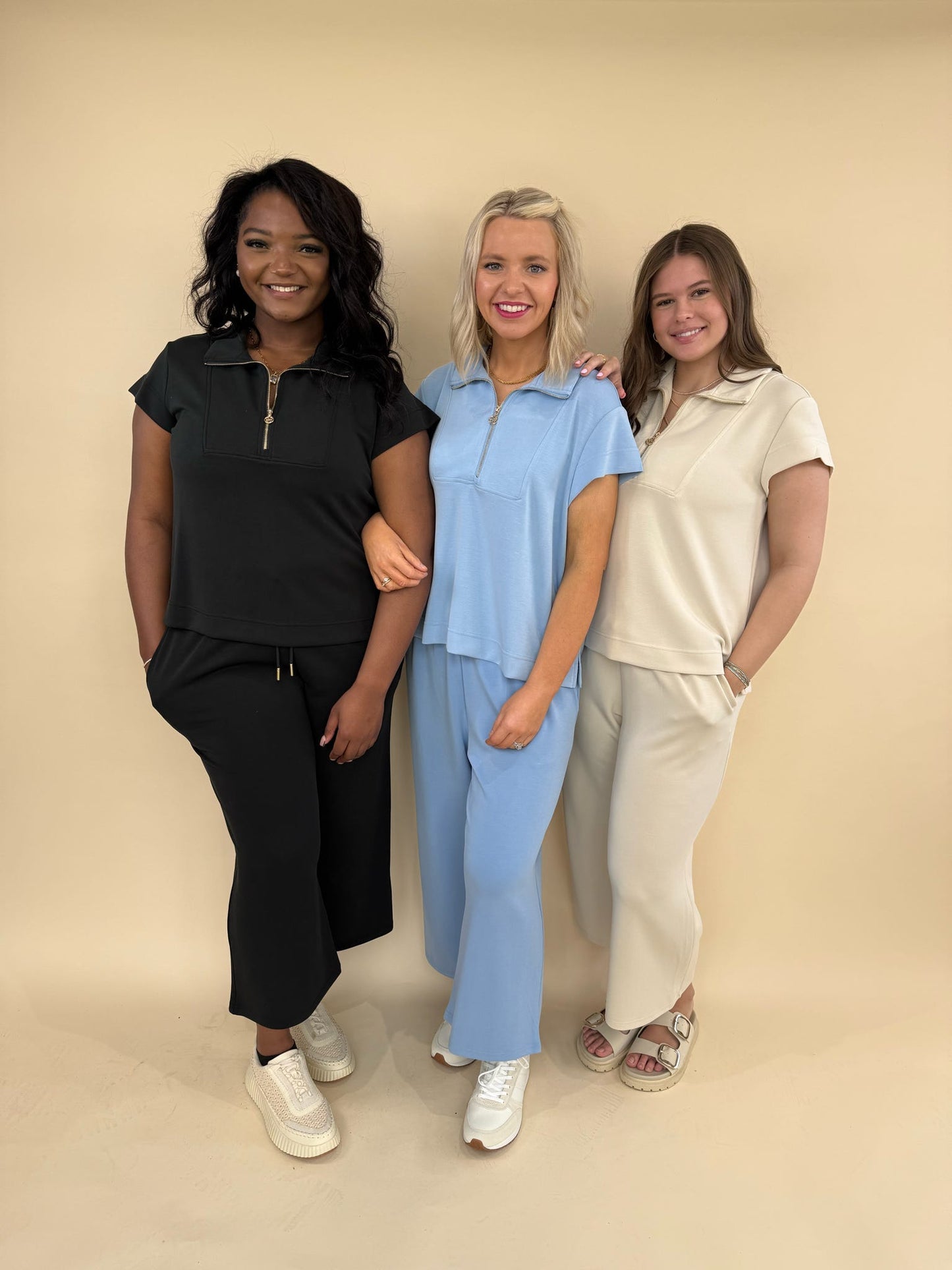 CloudSilk Weekend Set lounge outfit in black, blue, and sand featuring cap sleeve zip-collar top and cropped drawstring pants