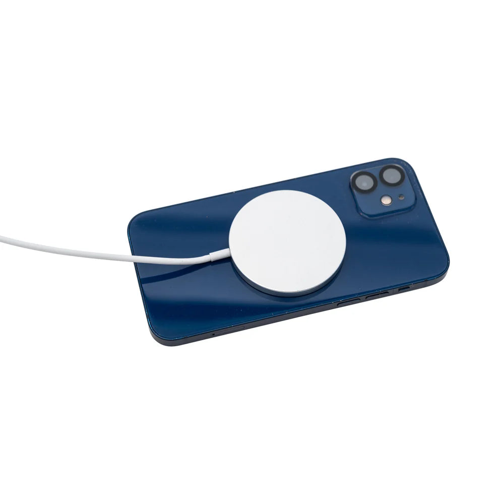 Blue phone with a white magnetic charging pad on a white background