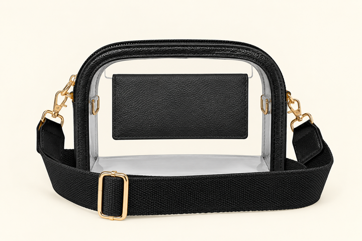 The Sideline Clear Crossbody Bag in black with clear PVC body, adjustable strap and gold-tone hardware