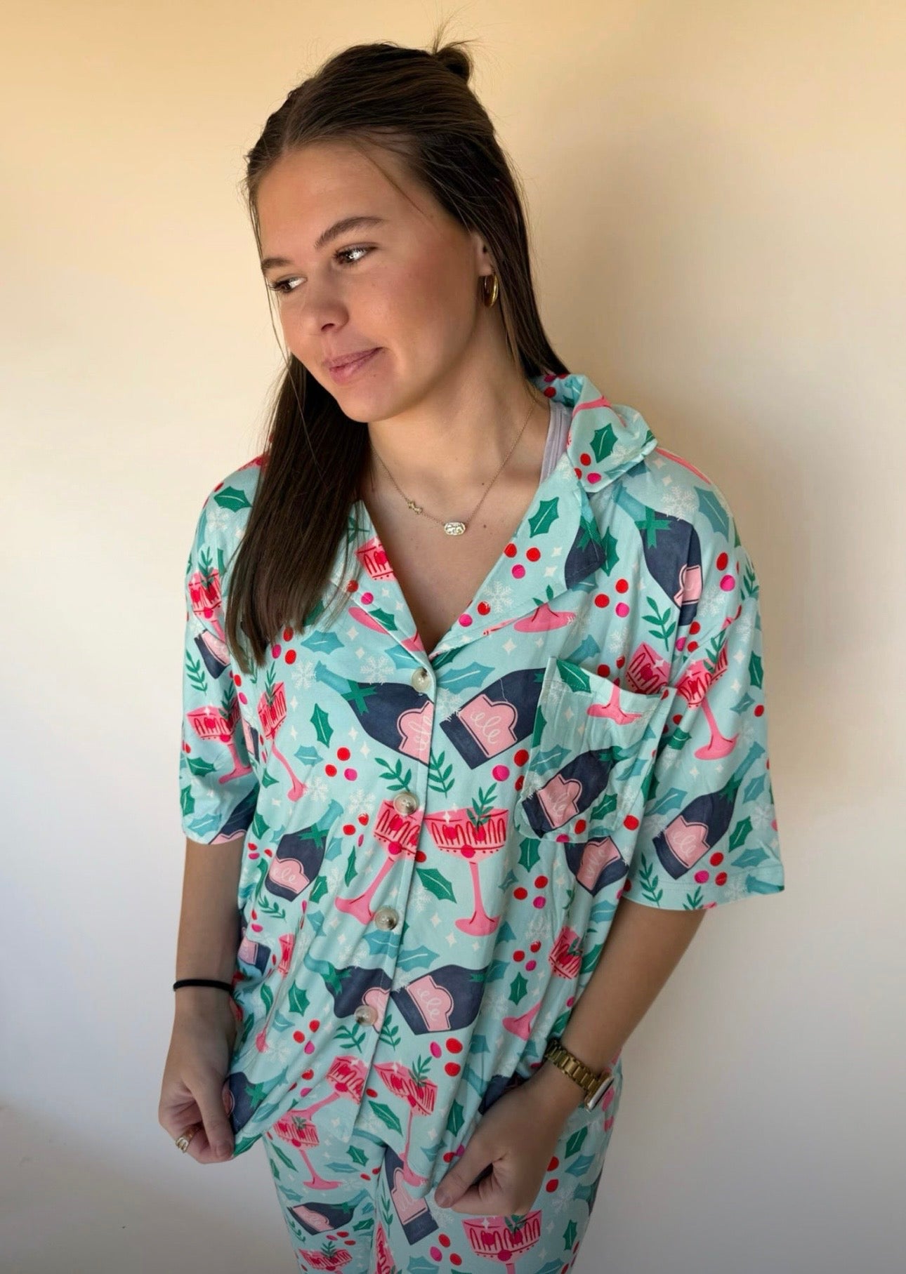 Woman wearing a holiday patterned shirt with a plain background