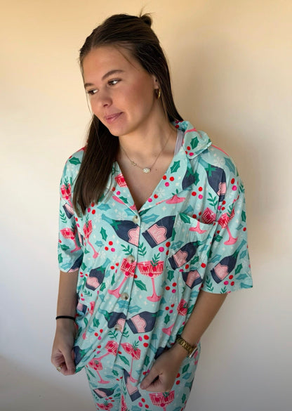 Woman wearing a holiday patterned shirt with a plain background