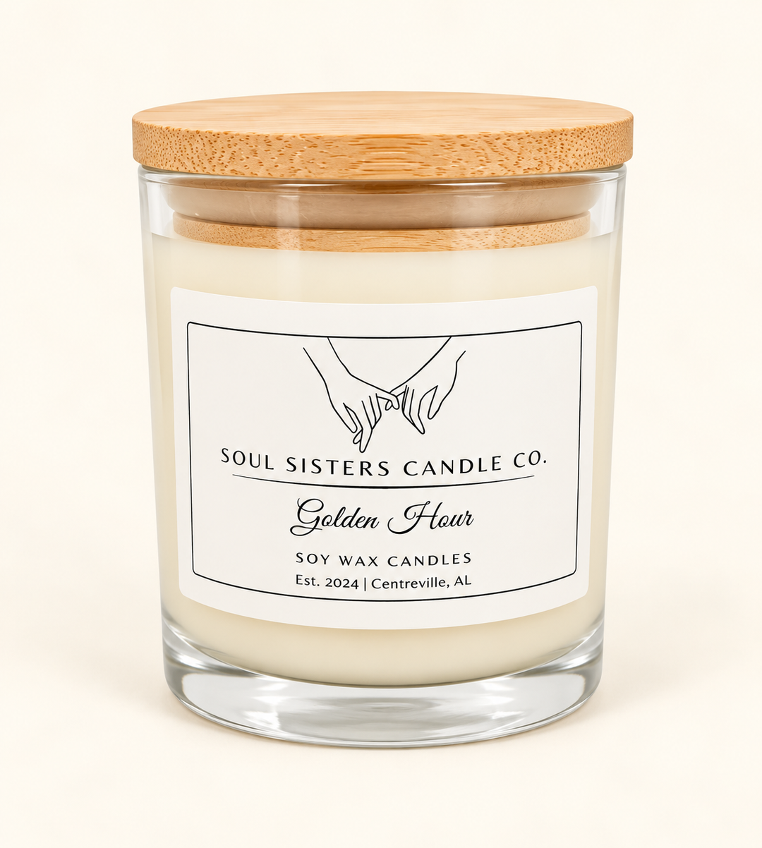 Soul Sisters Candle Co. Golden Hour soy wax candle featuring creamy ivory wax, a clear glass jar, natural bamboo lid, and white branded label on a cream studio background.