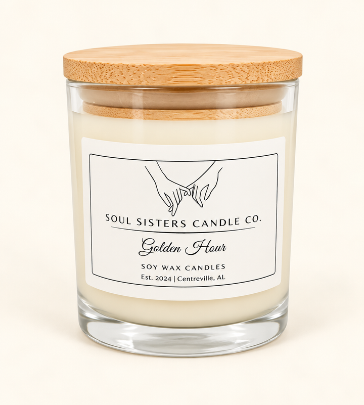 Soul Sisters Candle Co. Golden Hour soy wax candle featuring creamy ivory wax, a clear glass jar, natural bamboo lid, and white branded label on a cream studio background.