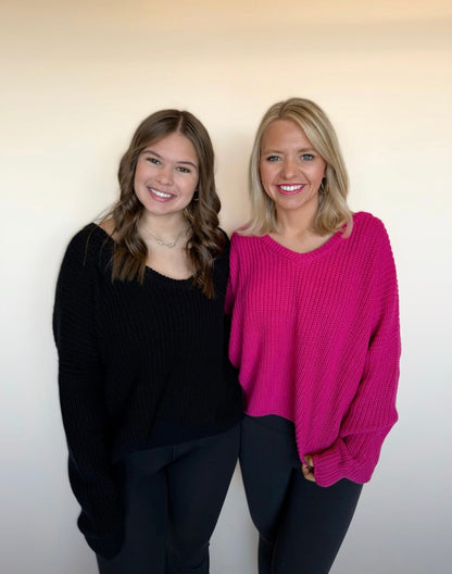 Two women standing side by side against a plain background