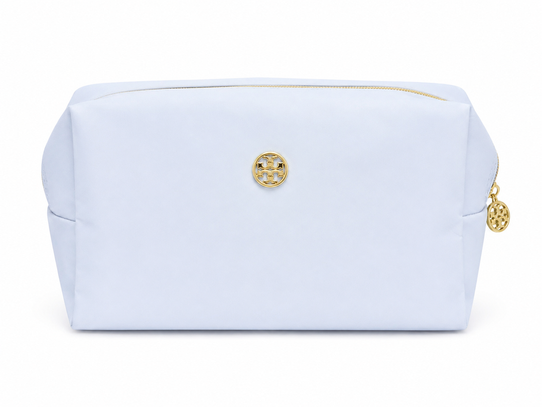 Light blue cosmetic bag with gold zipper and gold emblem, spacious travel makeup pouch for cosmetics, skincare, toiletries, and everyday beauty essentials.