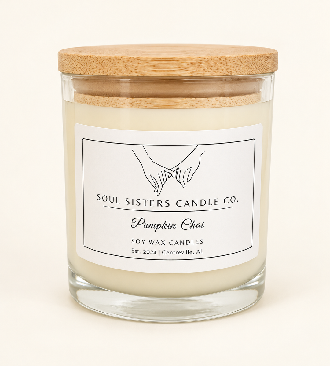 Soul Sisters Candle Co. Pumpkin Chai soy wax candle in a clear glass jar with natural wood lid, featuring pumpkin, brown sugar, and chai spice fragrance.