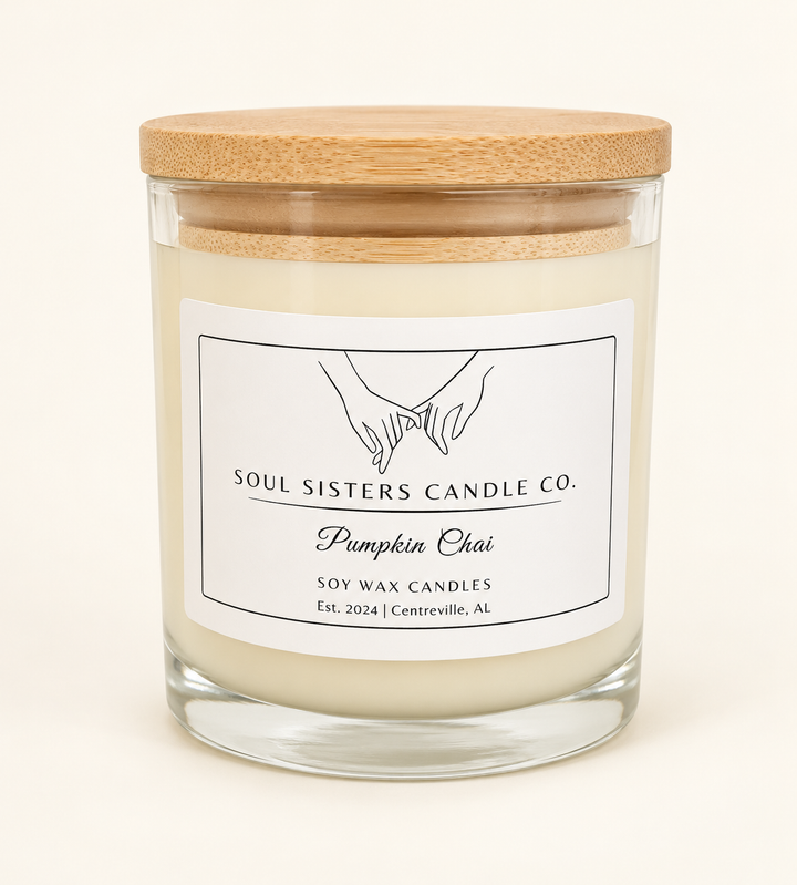 Soul Sisters Candle Co. Pumpkin Chai soy wax candle in a clear glass jar with natural wood lid, featuring pumpkin, brown sugar, and chai spice fragrance.