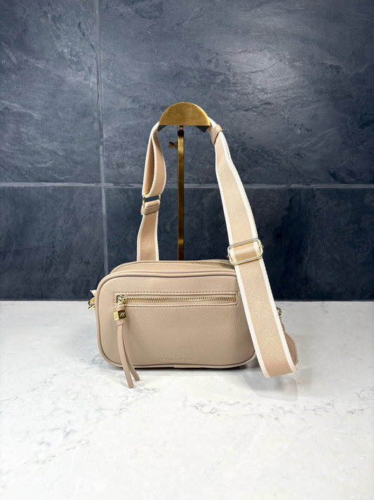 Lottie crossbody bag in light taupe vegan leather with adjustable striped strap and gold zipper hardware