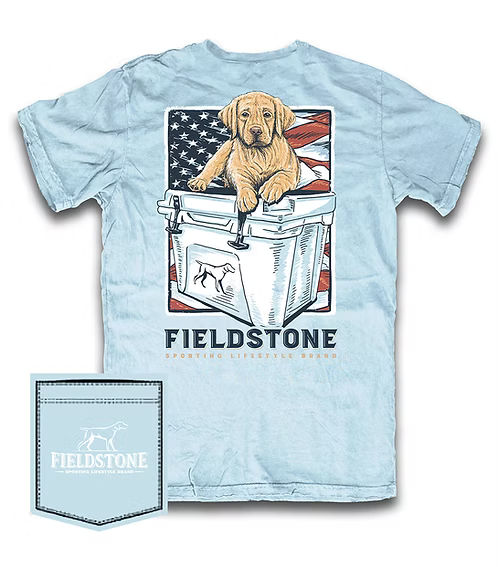Fieldstone Sporting Lifestyle Brand light blue graphic t-shirt featuring Labrador retriever puppy sitting on cooler with American flag backdrop, Southern outdoor apparel, hunting dog tee, patriotic comfort shirt