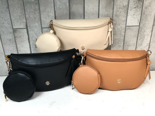 Set of black, beige, and brown leather bags on a gray tiled background