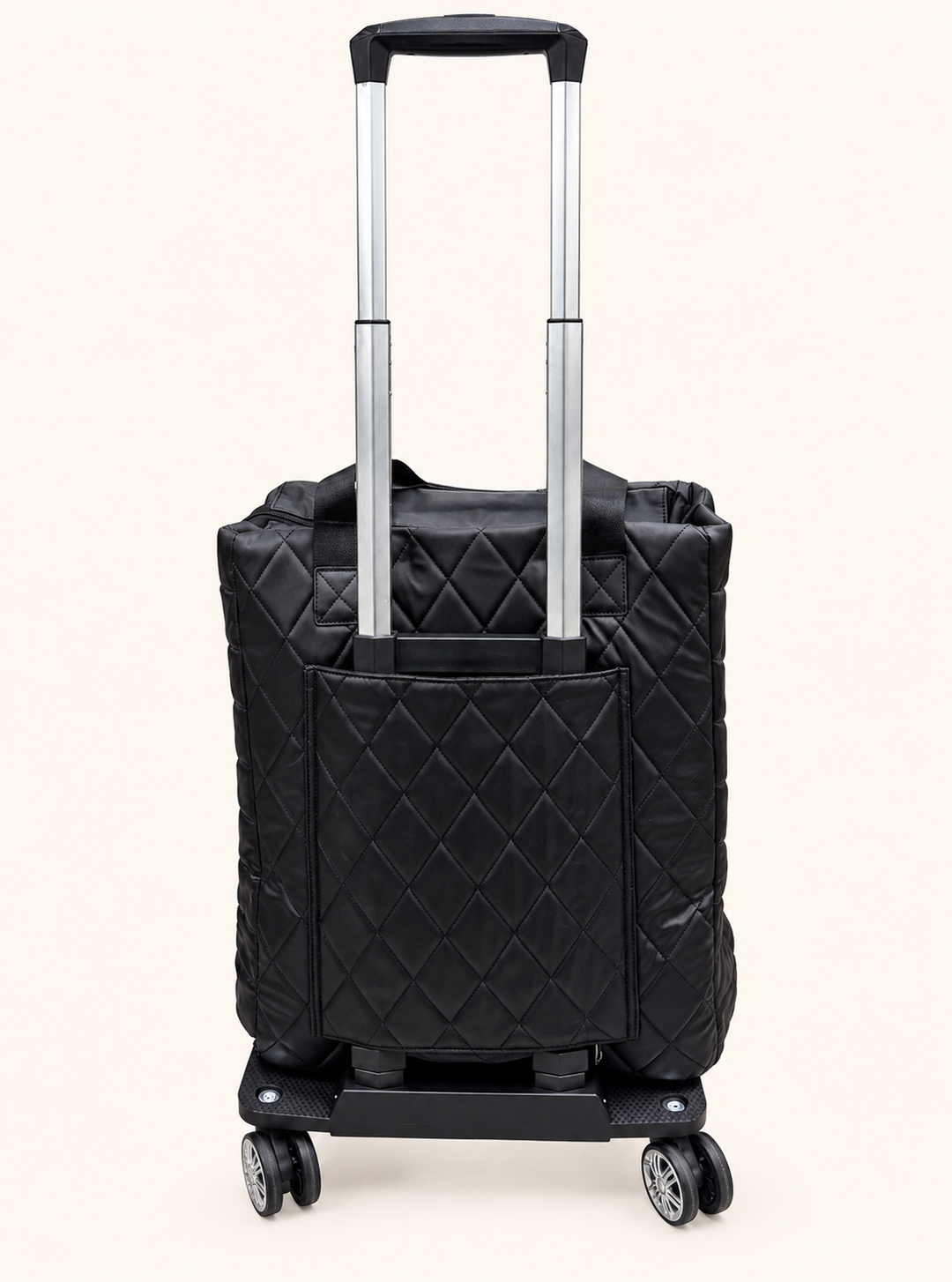 Back view of Simply Southern black quilted rolling travel tote featuring an extended telescoping handle, rear pocket, and swivel wheels.
 Copy