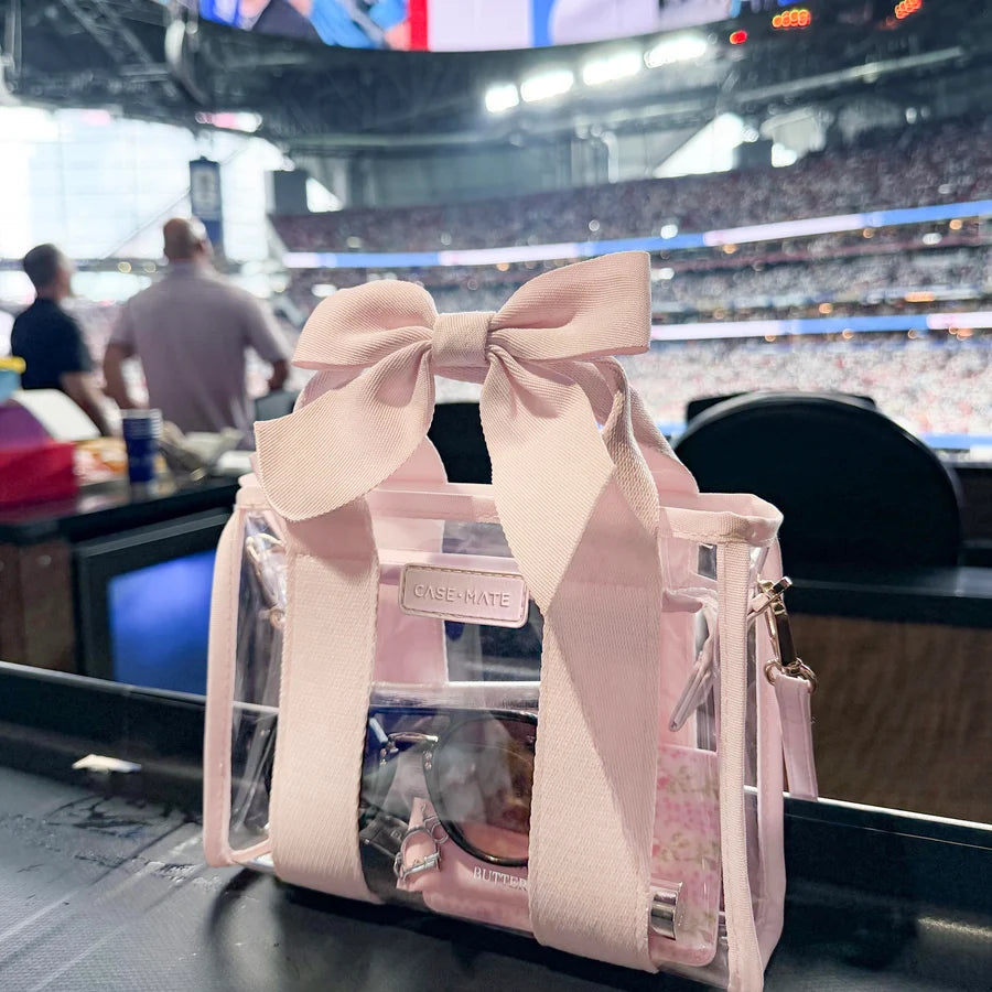 Case-Mate Ballet Pink Bow Jelly Stadium Bag at a sporting event featuring a stadium-approved clear design, pink bow and essentials inside.