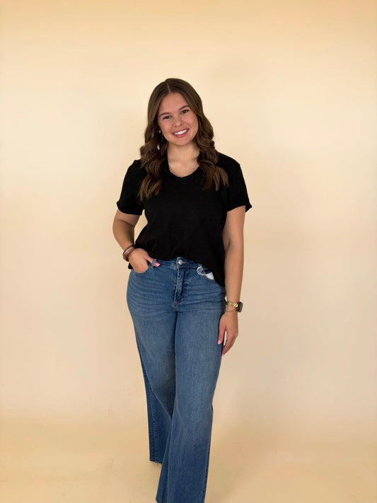 dear john flare jeans styled outfit women’s medium wash denim paired with black tee casual everyday boutique look