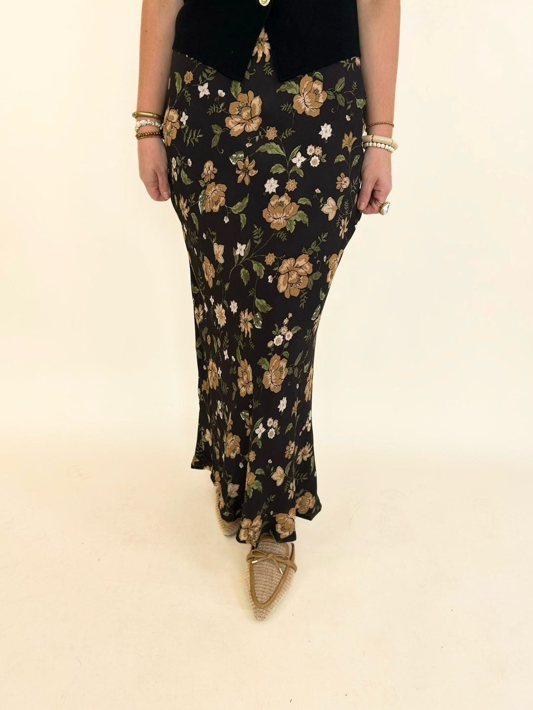 Close-up front view of the Elaina Floral Slip-On Midi Skirt in a black multi floral print with a flattering high-waisted silhouette.