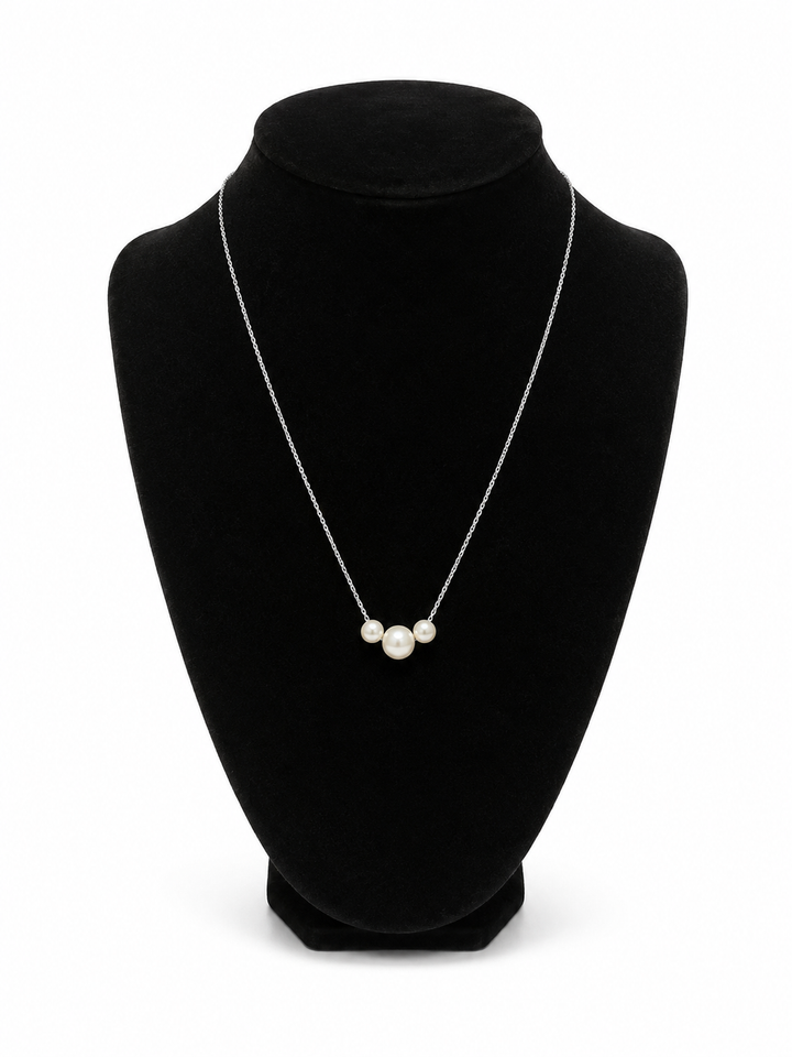 Three Pearl Sterling Silver Dipped Necklace displayed on a black velvet jewelry bust against a white studio background.