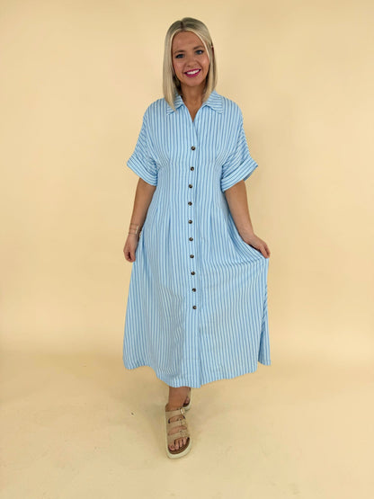 Light blue striped button down midi dress with short sleeves modeled for women’s boutique fashion